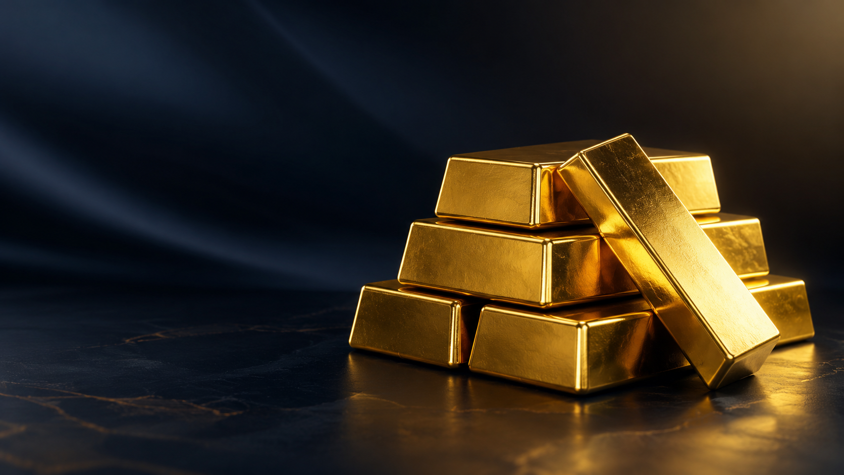 Stacked gold bars resting on a dark surface